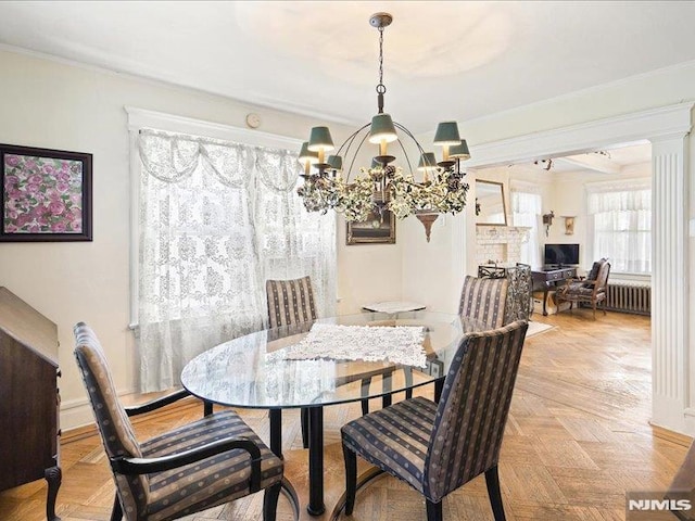 dining space featuring a notable chandelier, ornamental molding, and radiator