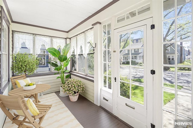 sunroom featuring french doors and ornamental molding