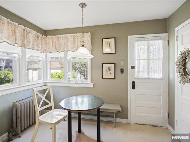 dining space featuring plenty of natural light, baseboards, and radiator heating unit
