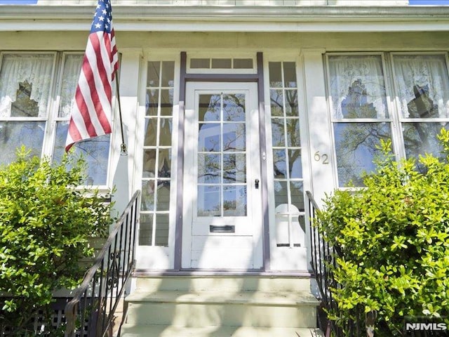 view of exterior entry with covered porch