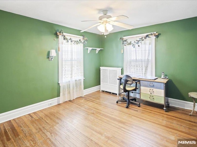 office with ceiling fan, baseboards, and wood finished floors