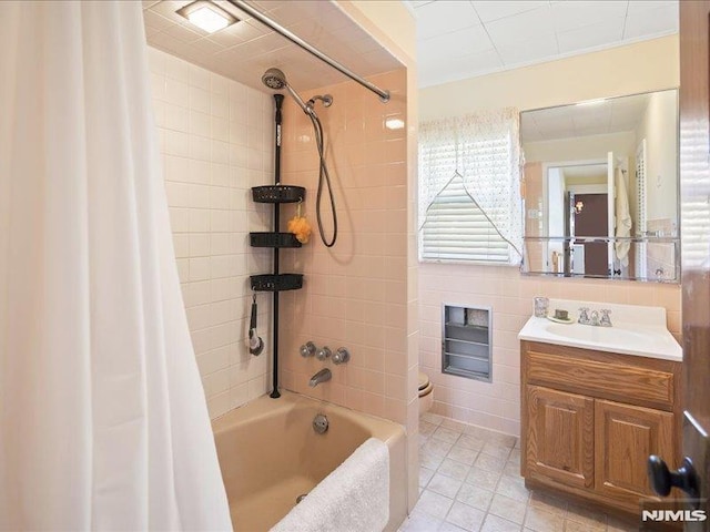 full bathroom featuring shower / bath combo with shower curtain, tile patterned flooring, toilet, and vanity