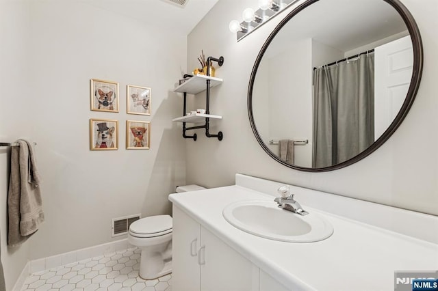 full bathroom with visible vents, vanity, toilet, baseboards, and tile patterned floors