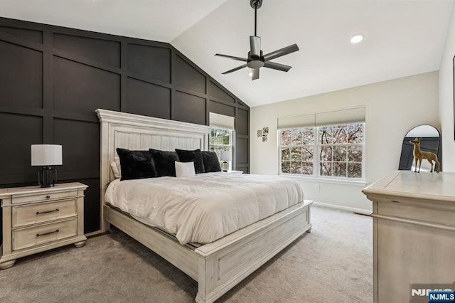 bedroom with ceiling fan, light carpet, baseboards, and lofted ceiling