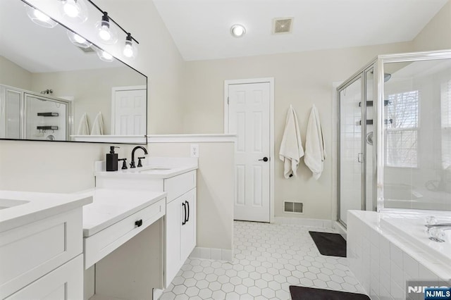 full bath featuring visible vents, a garden tub, and a shower stall