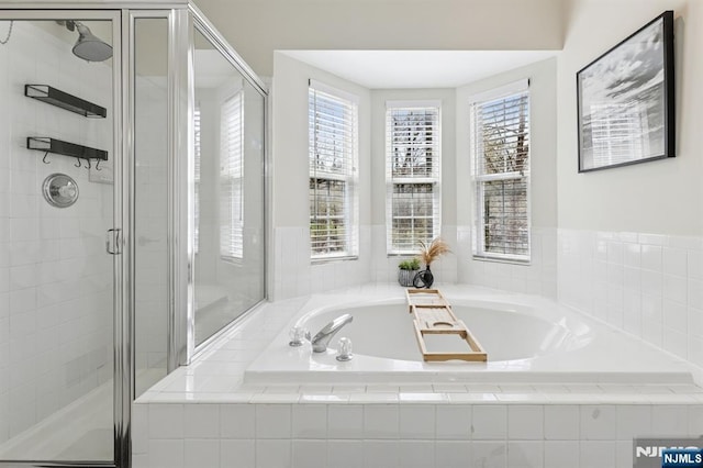 bathroom with a garden tub and a stall shower