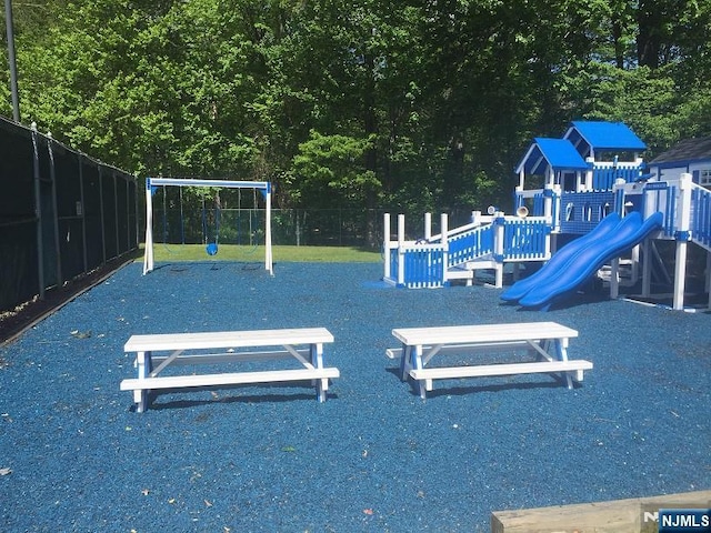 communal playground featuring fence