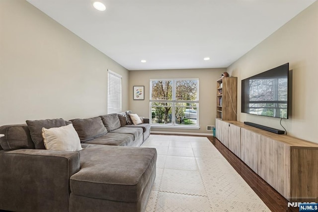 living area with recessed lighting, dark wood finished floors, and baseboards