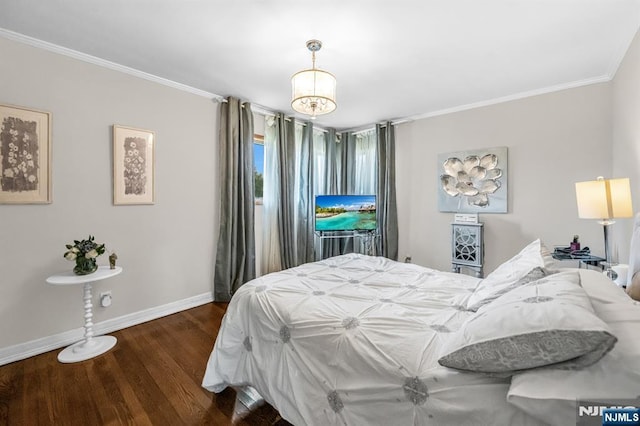 bedroom featuring baseboards, crown molding, and wood finished floors