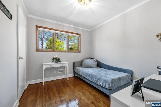 bedroom featuring visible vents, crown molding, dark wood finished floors, baseboards, and a chandelier