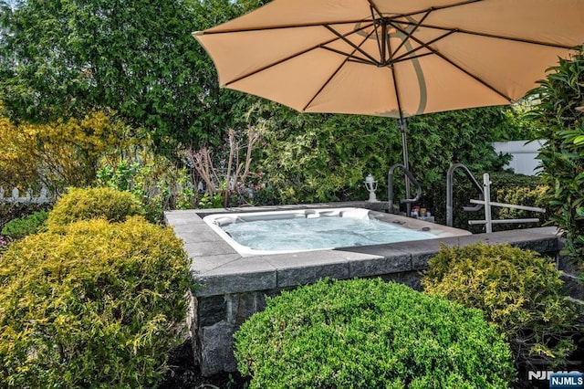 view of pool with an outdoor hot tub