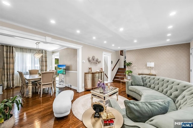 living room with stairs, baseboards, ornamental molding, and dark wood-type flooring