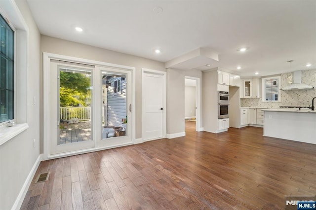119 Lenox Ave, New Milford, NJ 07646 - unfurnished living room with recessed lighting, baseboards, dark wood-style floors, and visible vents