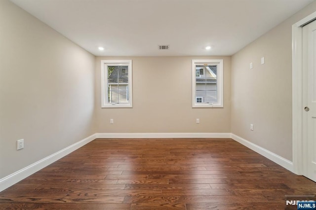 119 Lenox Ave, New Milford, NJ 07646 - spare room featuring baseboards, plenty of natural light, dark wood-type flooring, and visible vents