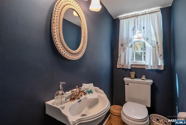 half bathroom with a sink and toilet