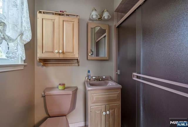 bathroom featuring vanity and toilet
