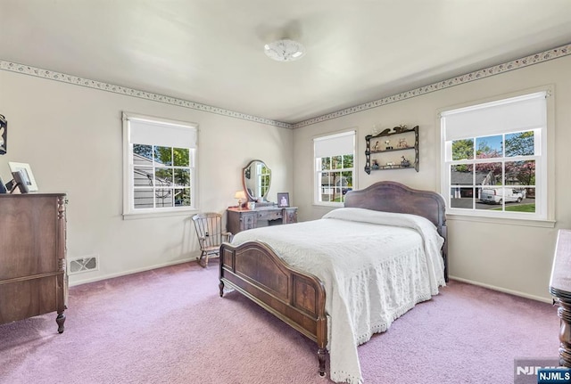bedroom featuring baseboards, carpet, and multiple windows