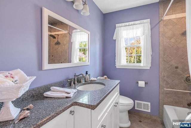 bathroom featuring visible vents, shower / tub combination, vanity, tile patterned floors, and toilet