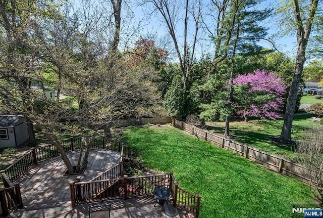 view of yard with a wooden deck and fence