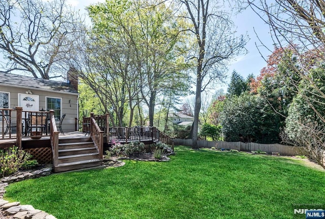 view of yard with fence and a deck
