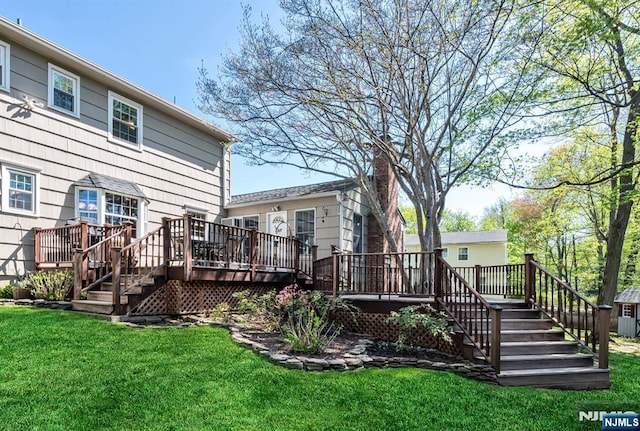 exterior space with stairway, a deck, and a yard