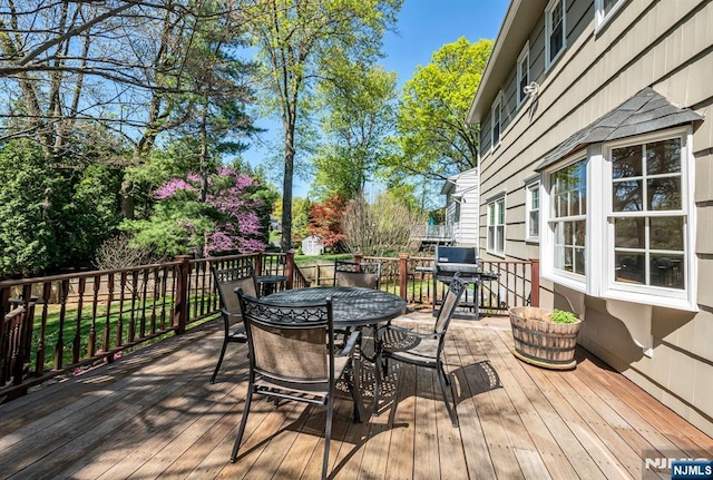 deck with outdoor dining space
