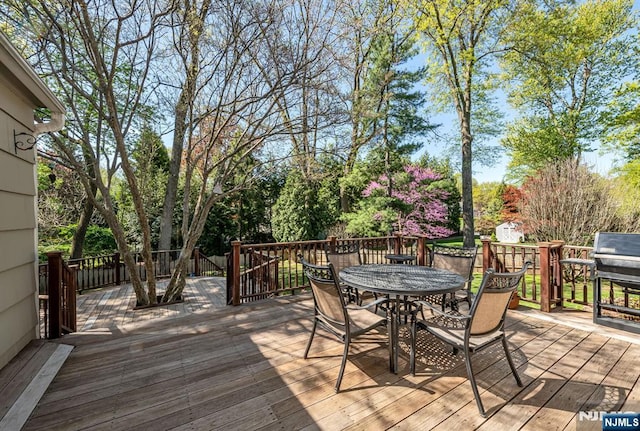 deck with outdoor dining area