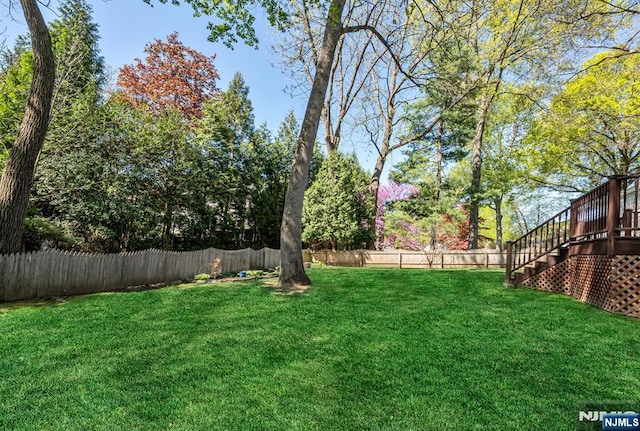 view of yard with stairs and a fenced backyard