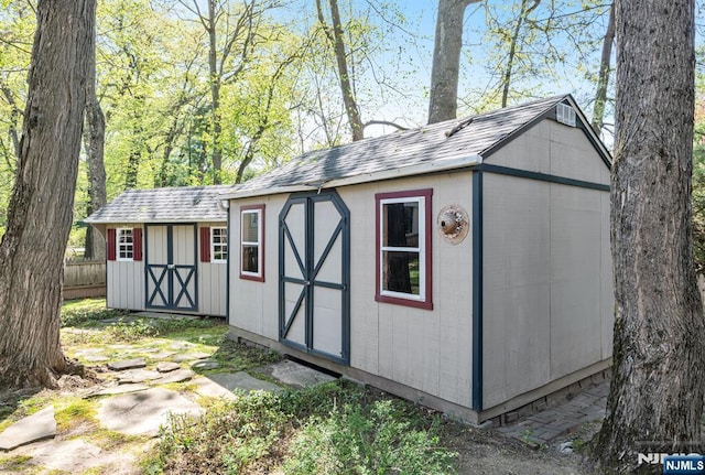 view of shed with fence