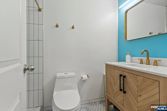 bathroom with vanity, tile patterned floors, and toilet