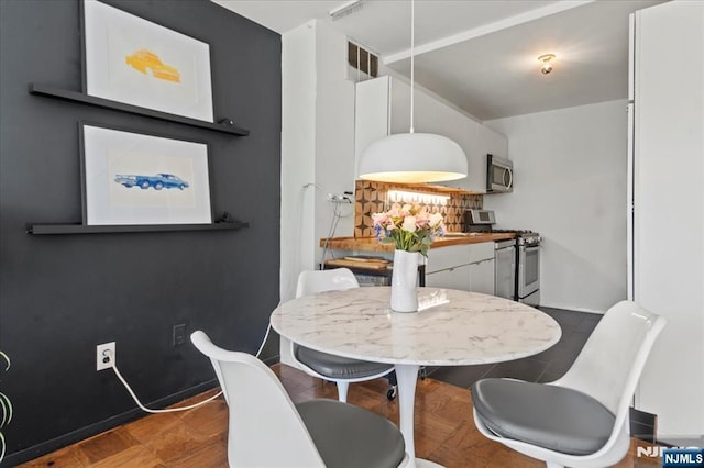 dining room featuring visible vents