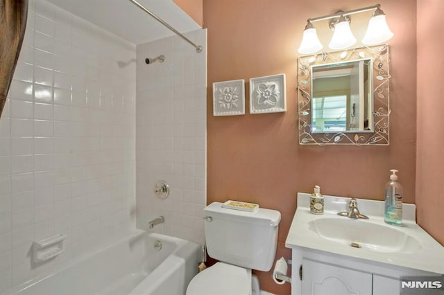 bathroom featuring shower / bathtub combination, toilet, and vanity