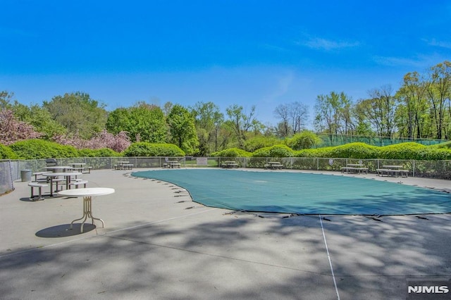 pool with fence and a patio area