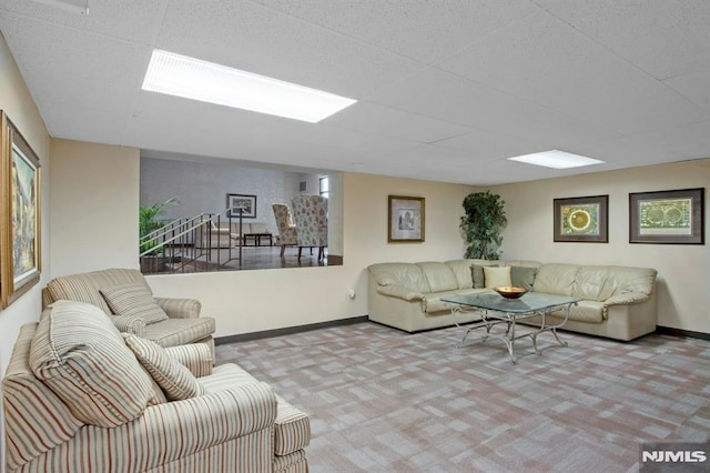 carpeted living room with baseboards