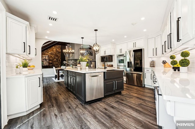 18 Fairview Dr, North Caldwell, NJ 07006 - kitchen with stainless steel appliances, white cabinetry, a chandelier, decorative backsplash, and recessed lighting