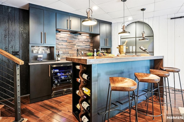 18 Fairview Dr, North Caldwell, NJ 07006 - indoor wet bar featuring beverage cooler, dark wood-style flooring, pendant lighting, decorative backsplash, and recessed lighting