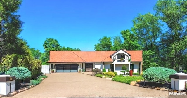 18 Fairview Dr, North Caldwell, NJ 07006 - view of front facade featuring a garage, concrete driveway, and stucco siding