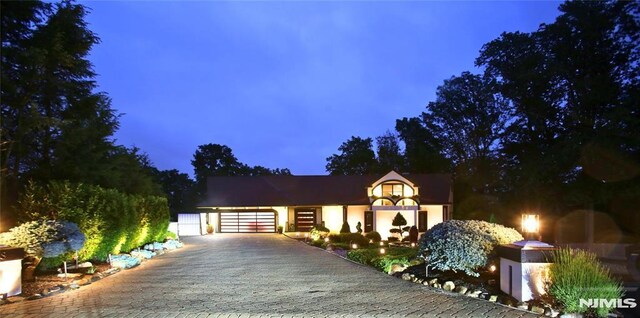 18 Fairview Dr, North Caldwell, NJ 07006 - view of front of home featuring decorative driveway, an attached garage, and stucco siding