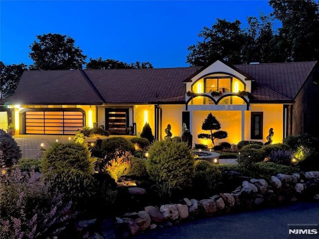 18 Fairview Dr, North Caldwell, NJ 07006 - view of front facade featuring an attached garage, stucco siding, and driveway