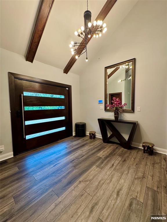 18 Fairview Dr, North Caldwell, NJ 07006 - foyer entrance featuring a chandelier, wood finished floors, and baseboards