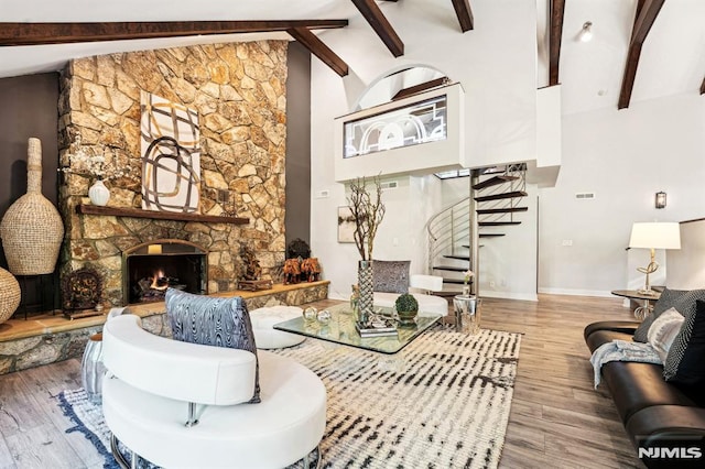 18 Fairview Dr, North Caldwell, NJ 07006 - living room with a stone fireplace, stairway, beamed ceiling, wood finished floors, and high vaulted ceiling
