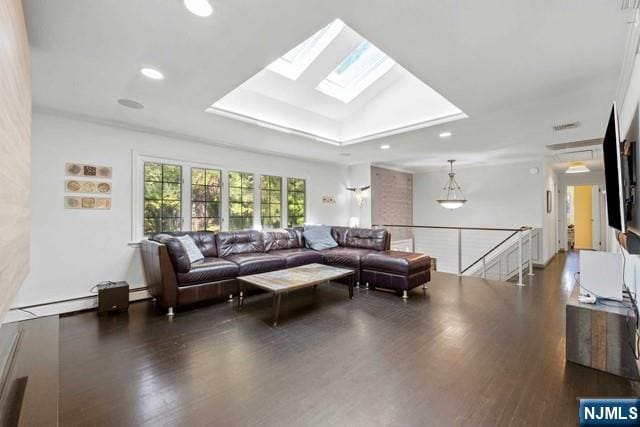 living area featuring recessed lighting, a raised ceiling, wood finished floors, and a skylight
