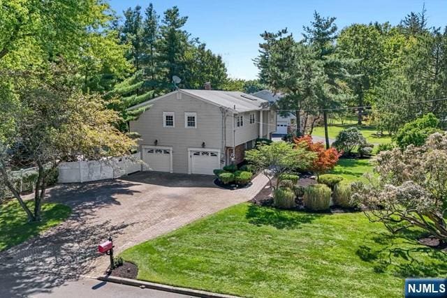 view of property exterior with an attached garage and driveway