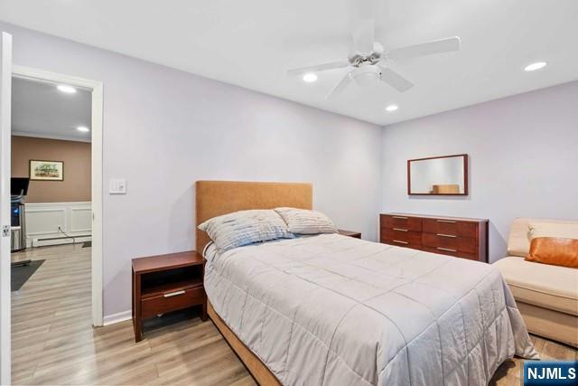 bedroom with recessed lighting, a ceiling fan, and light wood-style floors