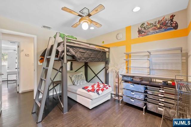 bedroom with wood finished floors and visible vents