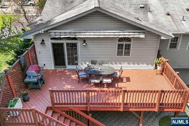 wooden terrace featuring outdoor dining space