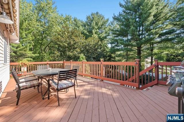wooden terrace featuring outdoor dining area