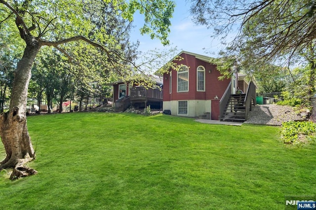 exterior space with stairs and a lawn