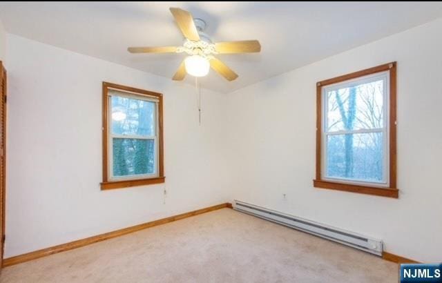 unfurnished room featuring baseboards, light carpet, and baseboard heating