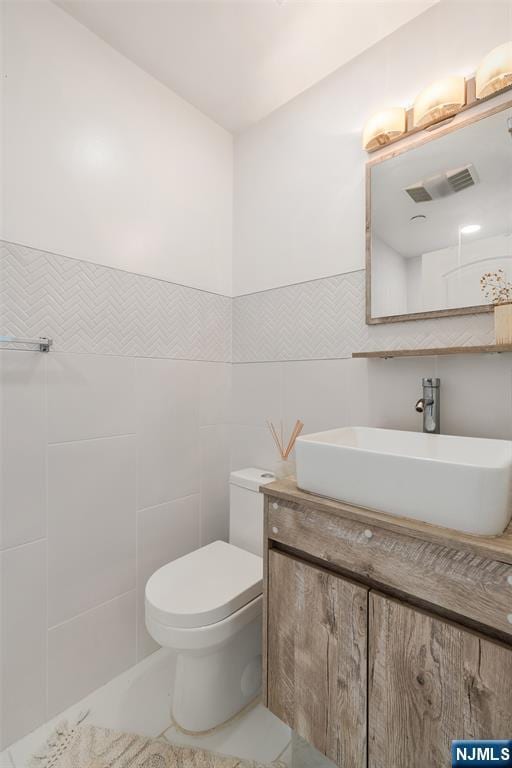 518-536 Gregory Ave Unit C408, Weehawken, NJ 07086 - half bath featuring tile walls, vanity, and toilet